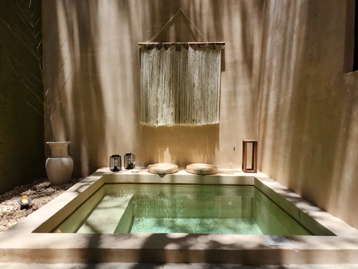 Indoor spa pool lit by candlelight